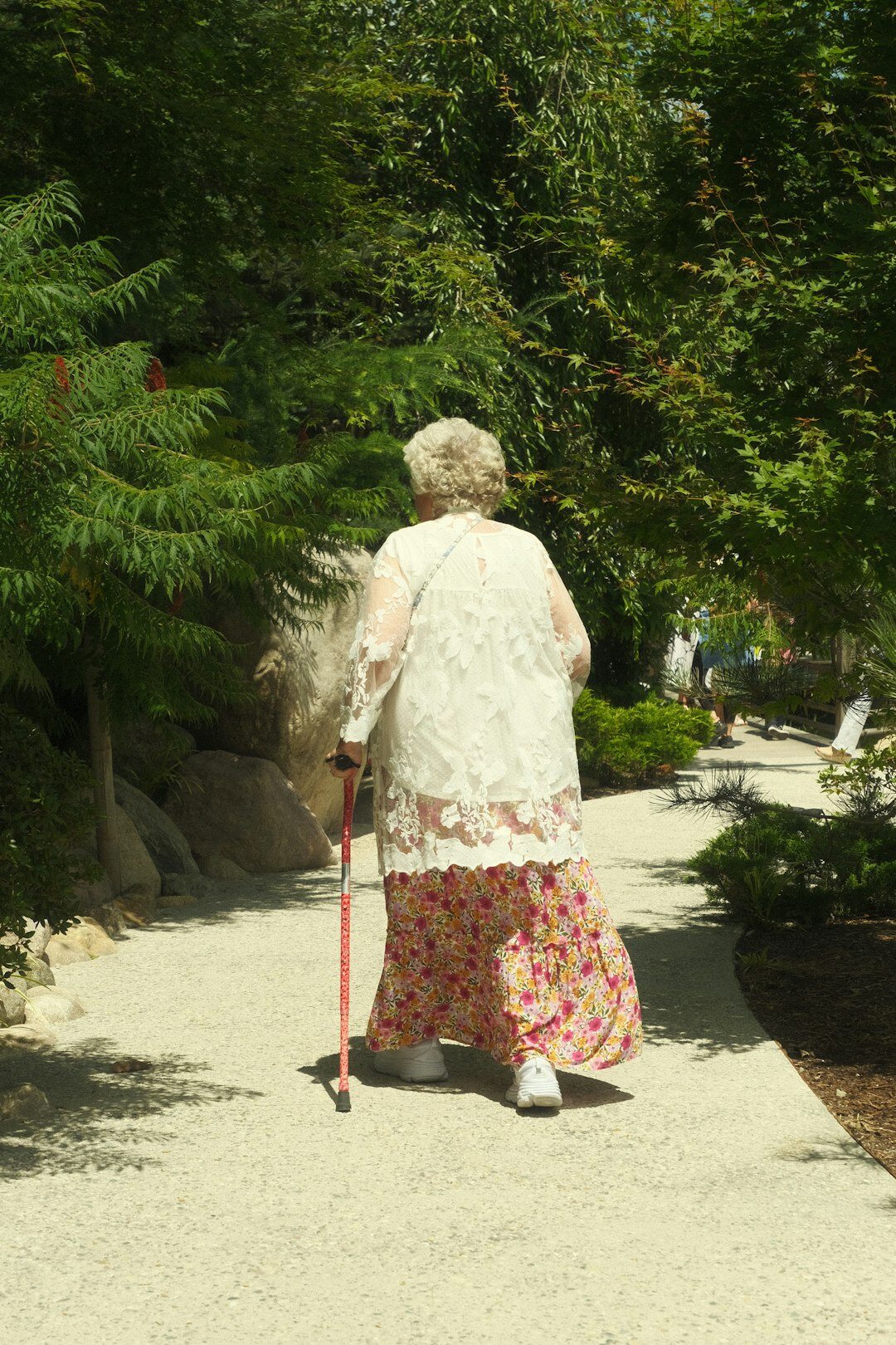 Elderly woman standing in her garden on Bornholm