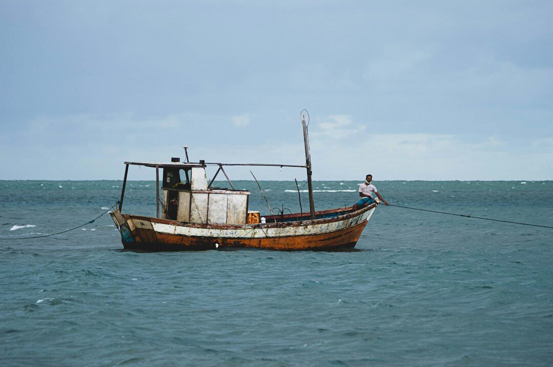 Fisherman standing beside his boat at Vesterhavet
