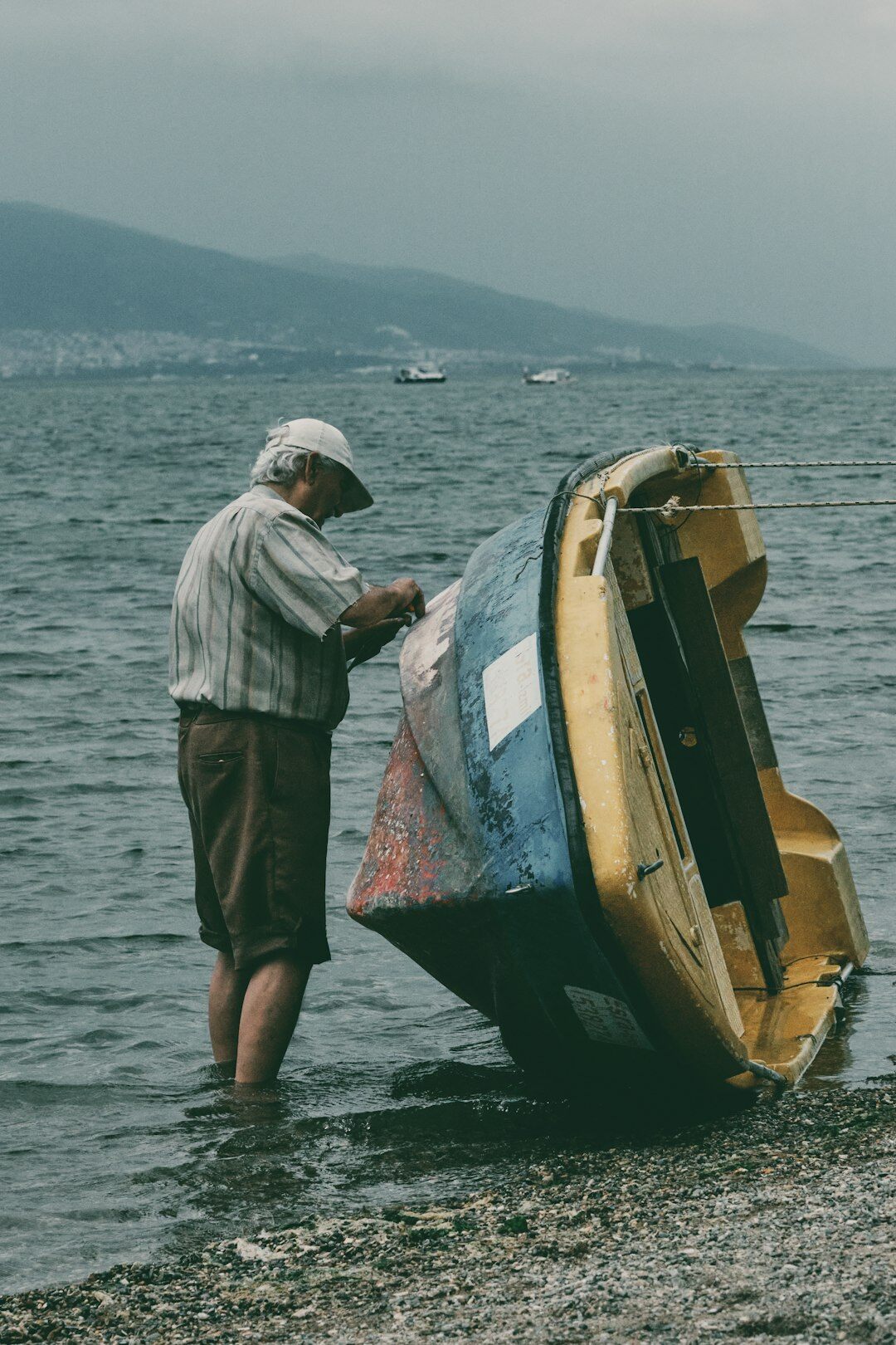 elderly fisherman by boat